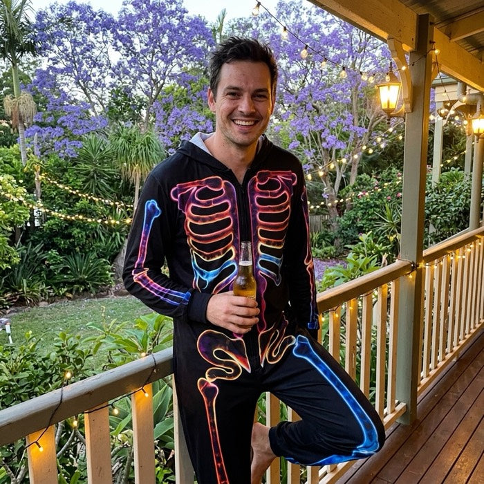 Man in a skeleton print pyjama set on a verandah at dusk